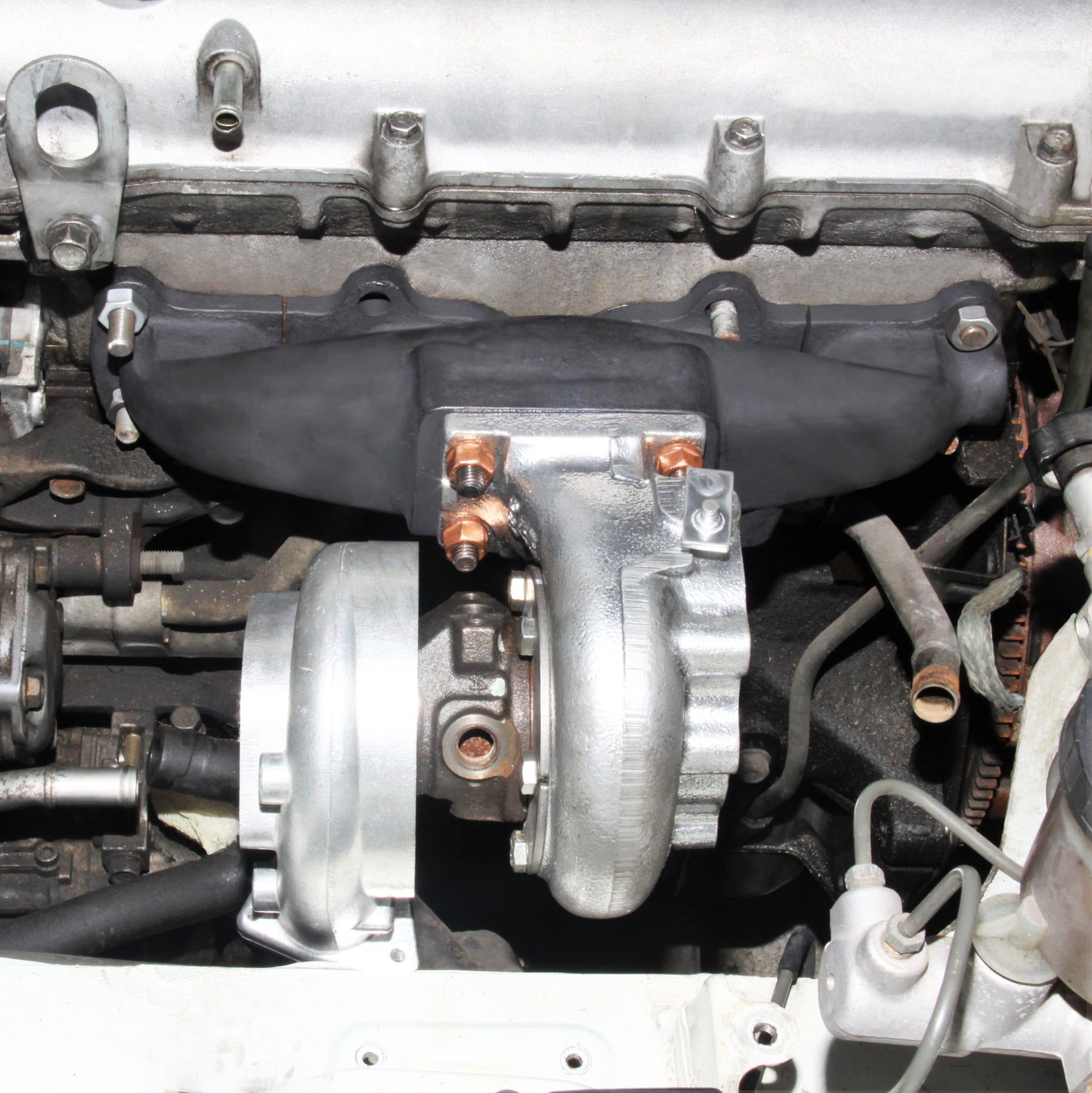 Blip Speed 1.8l Miata Turbo Manifold mounted with t25 frame turbo as a part of a BEGI Miata turbo kit